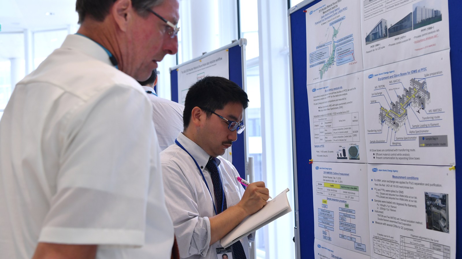 Researchers reviewing methodology and benchmarking materials